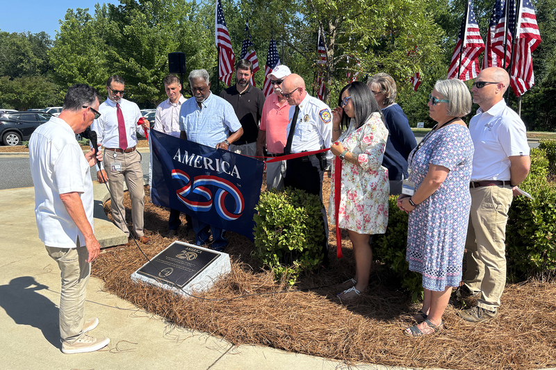 The Mayor reads the inscription on the plaque