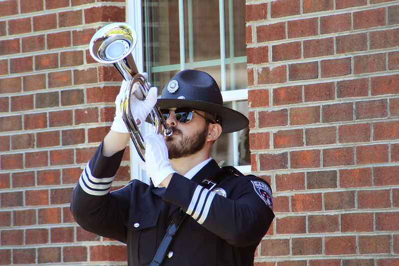 Officer playing trumpet at the National Police Week Memorial Service