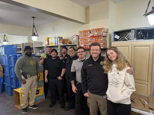 Officer assisting with drivers picking up food