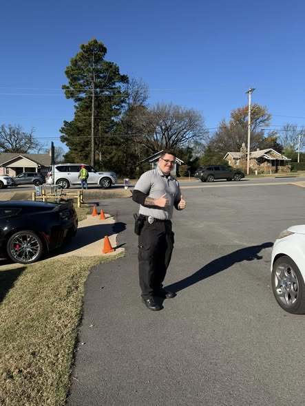 Officer assisting with drivers picking up food