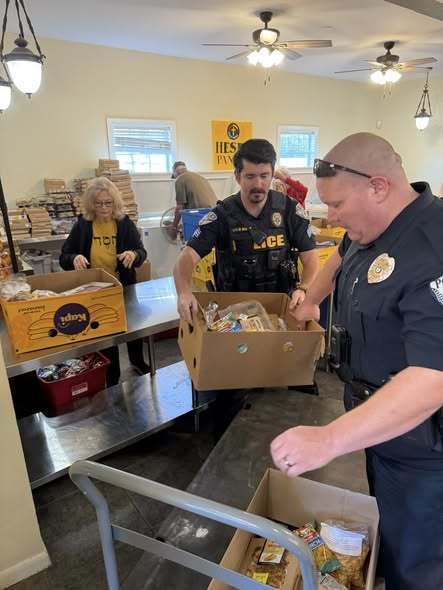 Officer assisting with drivers picking up food