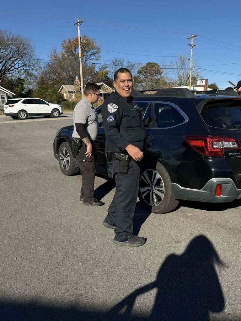 Officer assisting with drivers picking up food