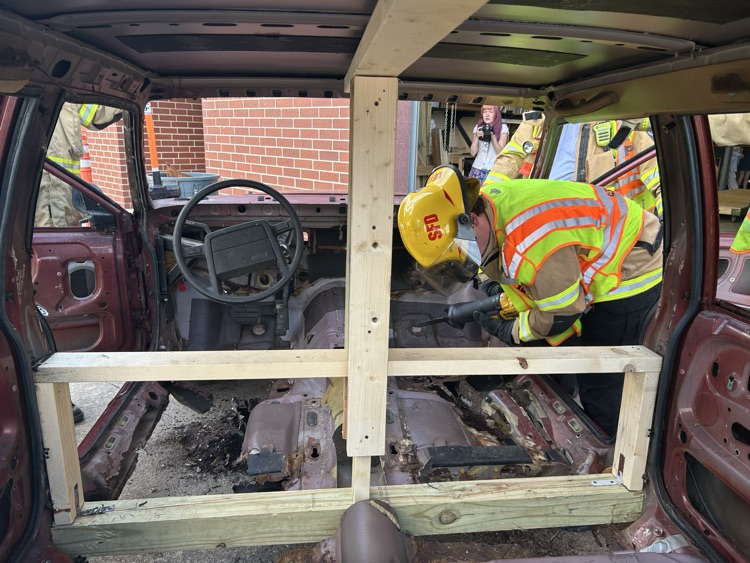 firefighters working on vehicle prop
