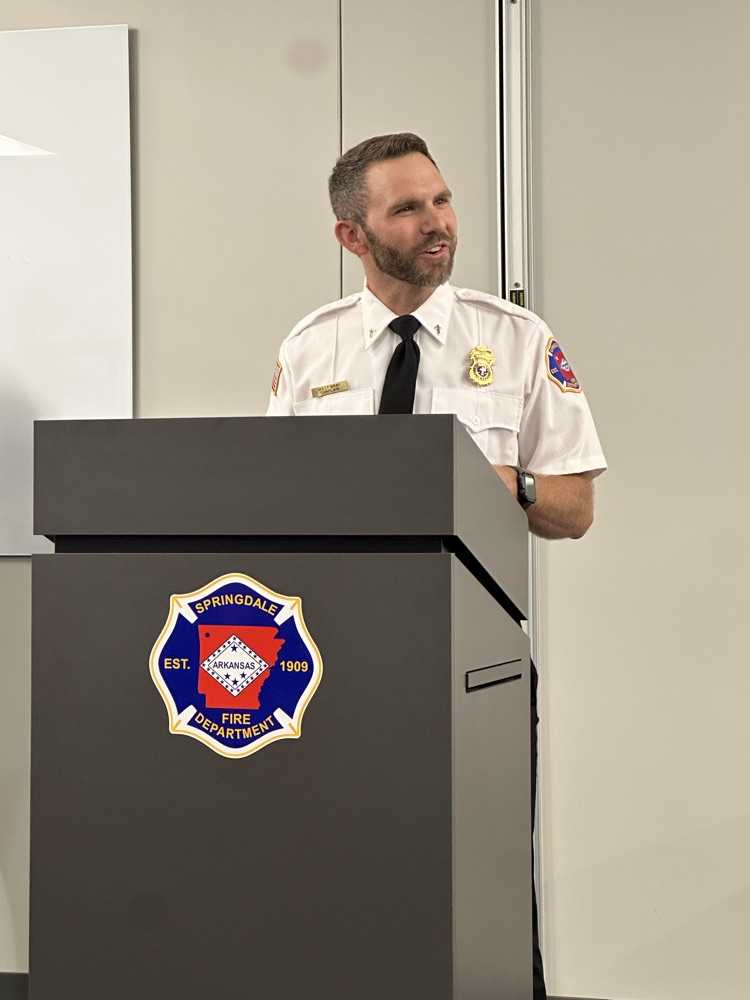 Chaplin speaking at pinning ceremony