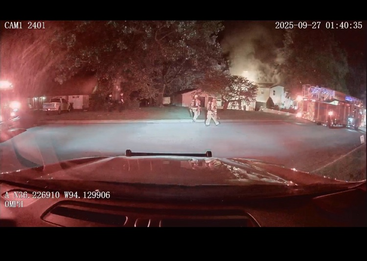 house on fire with firefighters in photo