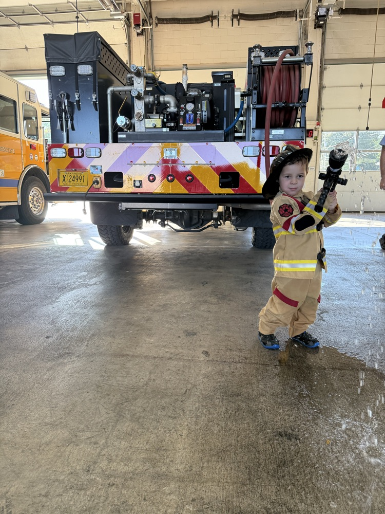 little boy with firehose