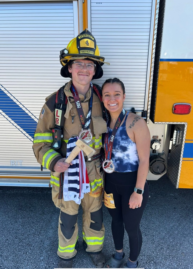 firefighter and his wife in front of fire engine