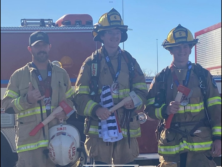 firefighters after marathon race with trophy's