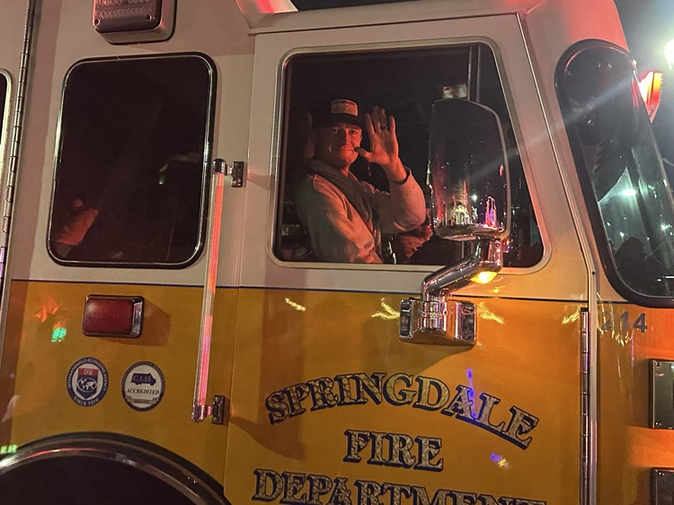 firefighter waiving in parade