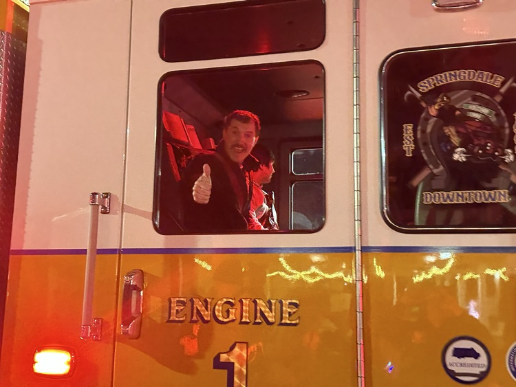 firefighter waving in parade