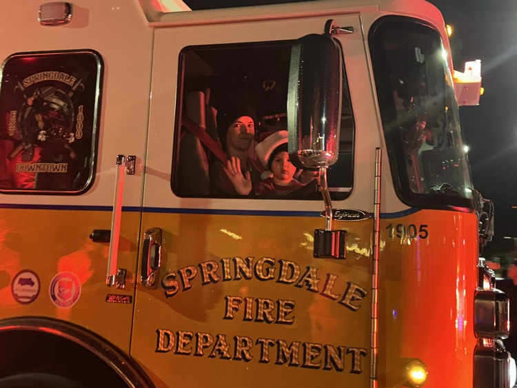 little boy in a fire truck 