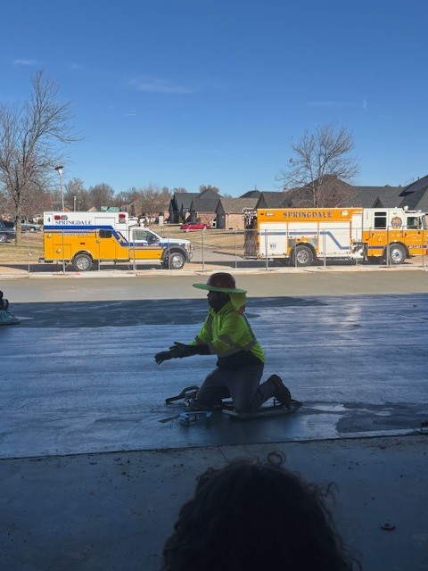 Worker installing a horseshoe in concrete.
