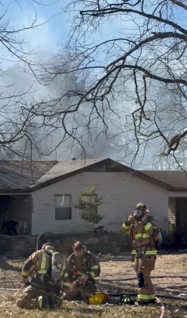firefighters in front of house