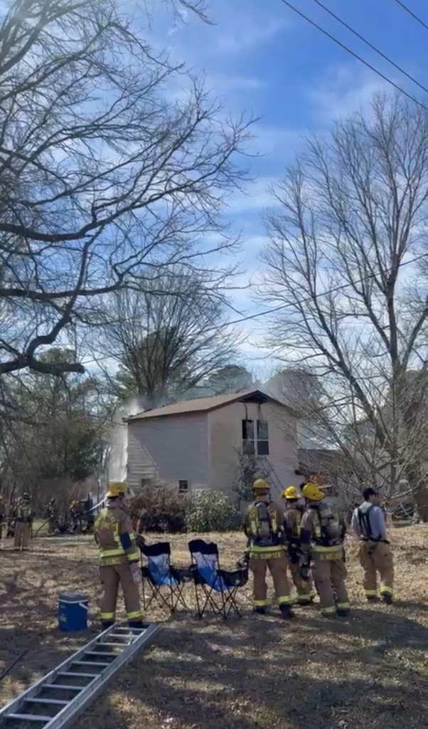 firefighters in front of house