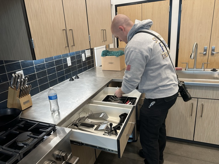 firefighter putting up new silverware in drawer