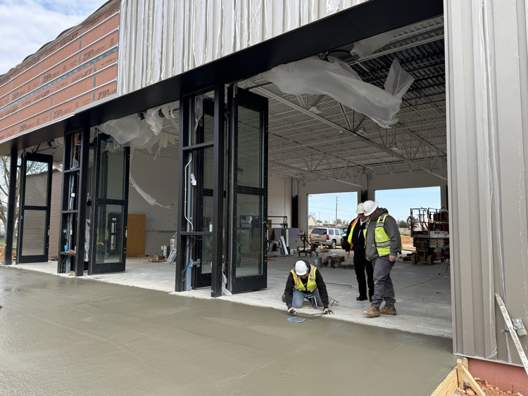 workers placing horseshoes in concrete