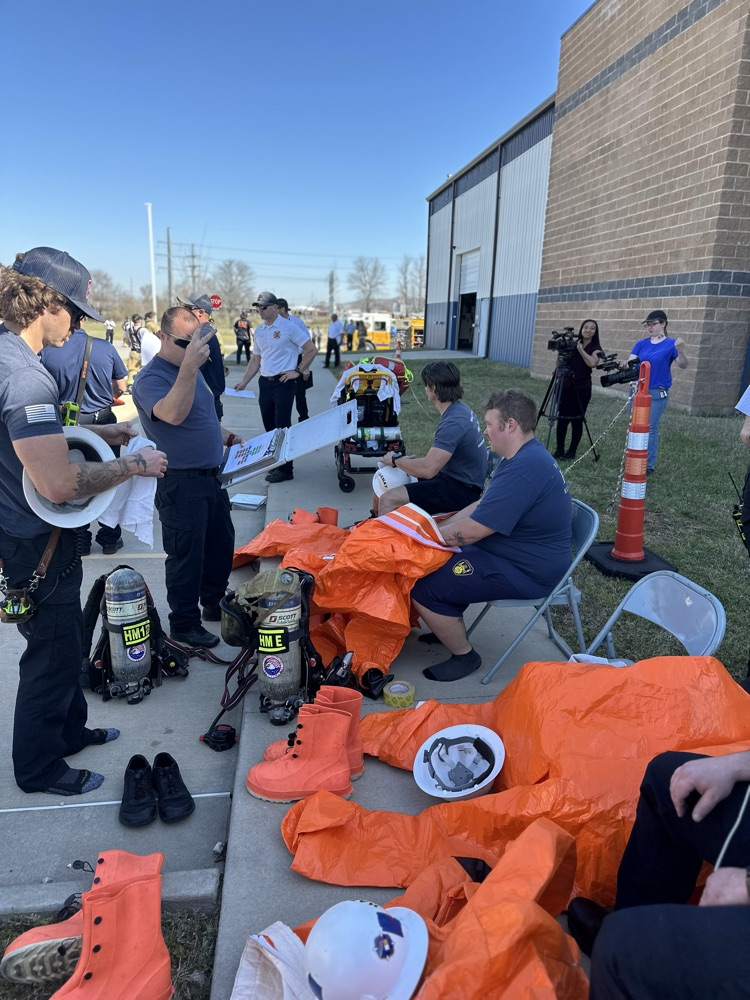 firefighters getting suited up to work at a hazmat drill