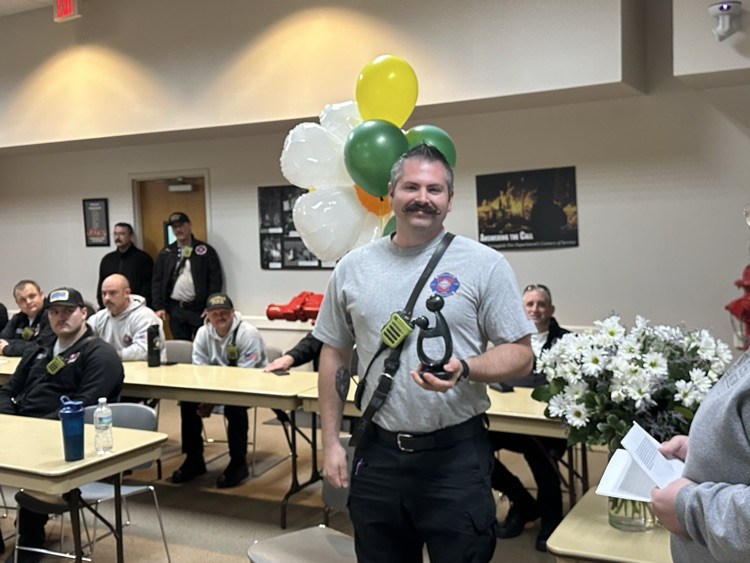 Firefighter holding an award