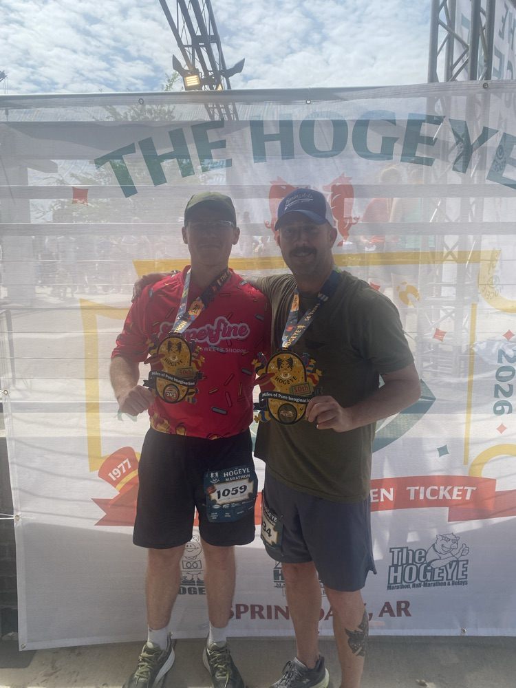 two firefighter with medal from completing marathon