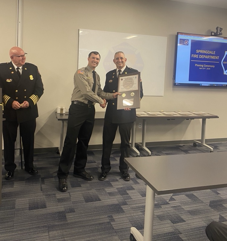 firefighter with chief recieving award