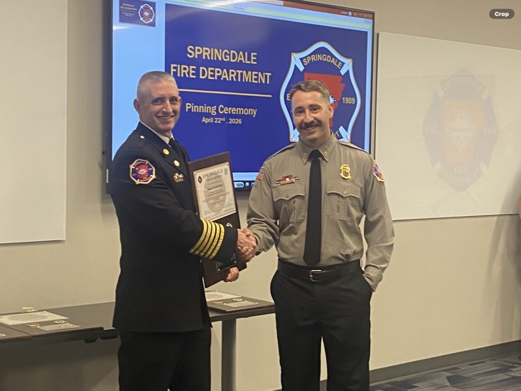 firefighter with chief being presented award