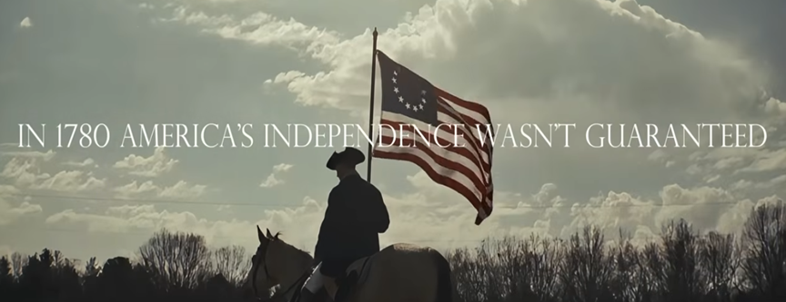 1780's re-enactor soldier on horseback holding American flag - screen says "In 1780, America's independence wasn't guaranteed."