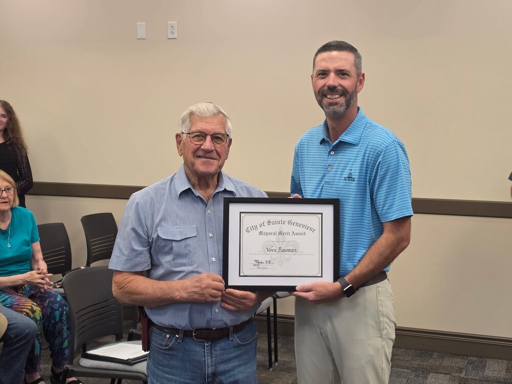 Mayor Brian Keim presenting award to Vern Bauman