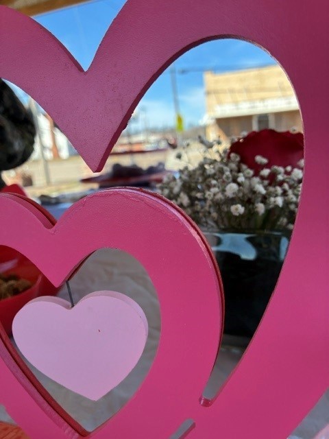 pink herts with rose and white flowers in background