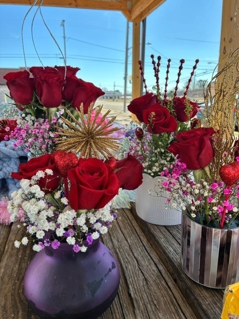 flowers in vased, red roses and white, pink, purple flowers in multicolored vases