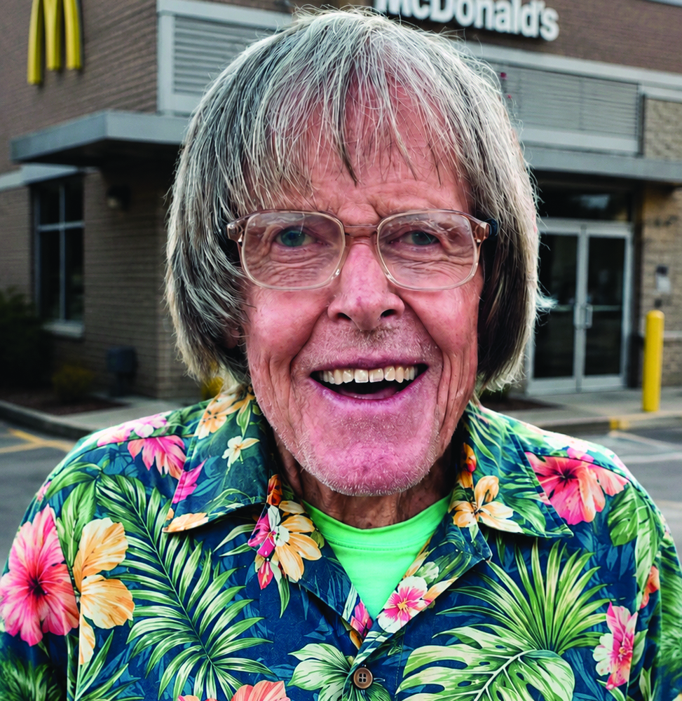 Joe Lyons smiling standing in front of a McDonalds