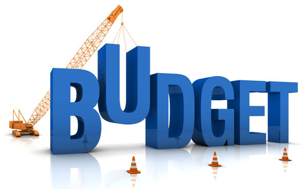 BUDGET in all blue caps with a crane lowering the U in the word budget