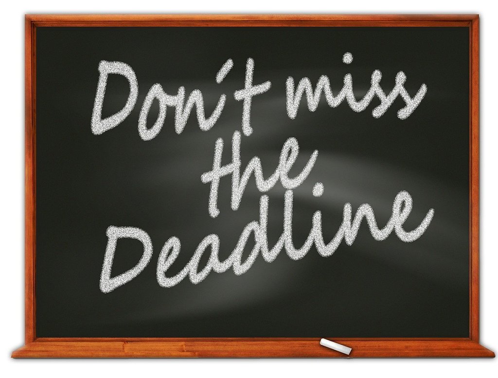 Don't Miss the Deadline written in white chalk on a blackboard