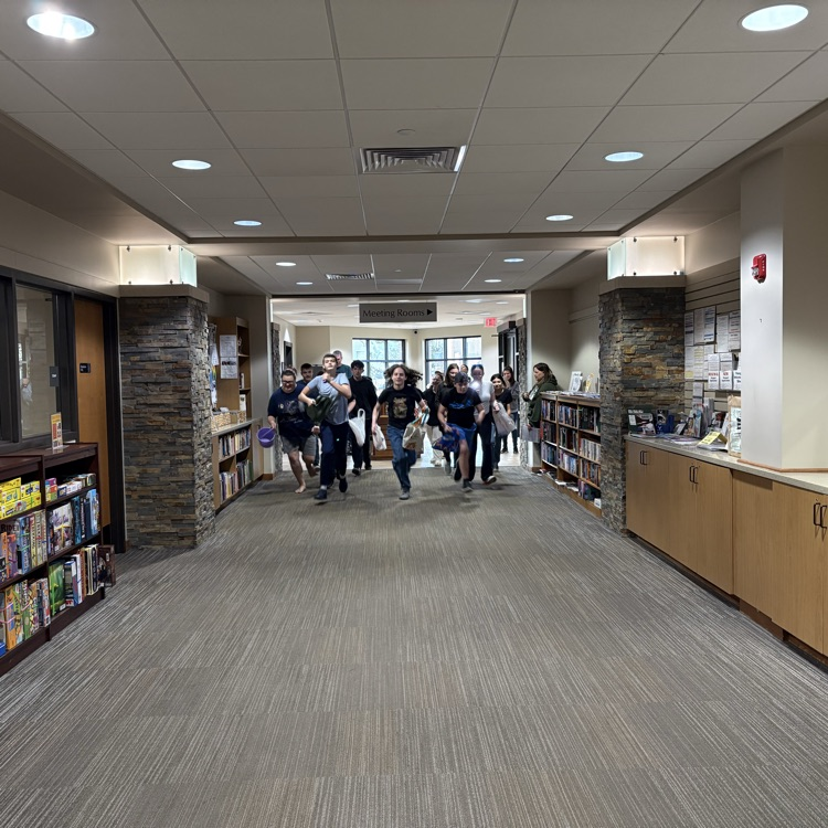 teens running down an empty library entrance 
