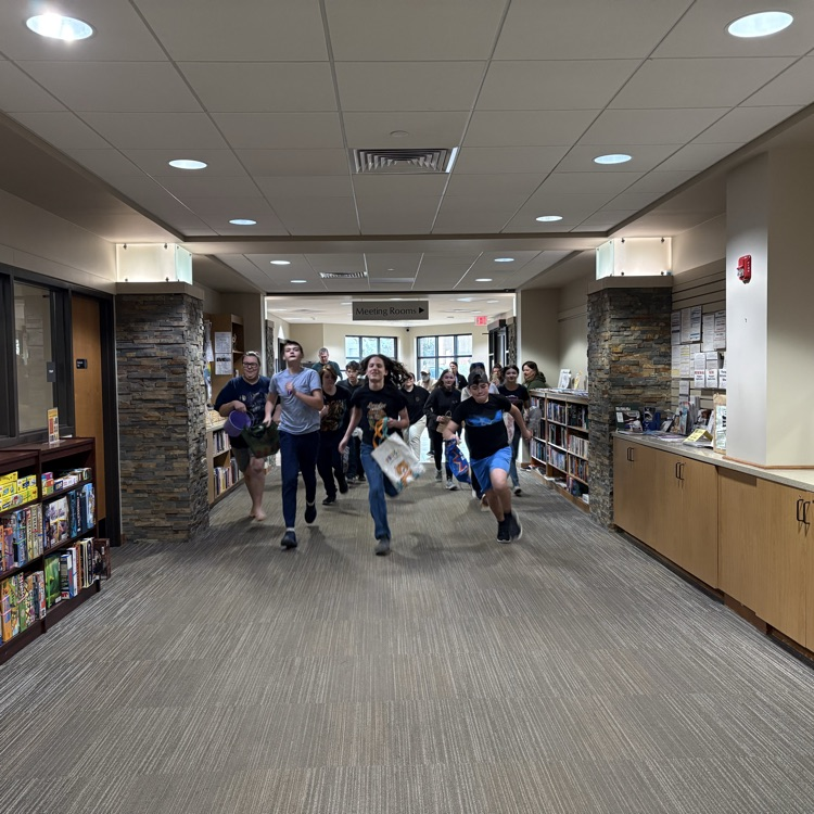 teens running down an empty library entrance