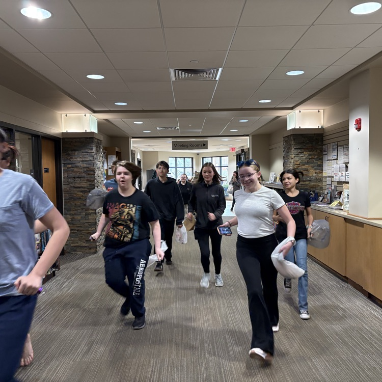 teens running down an empty library entrance