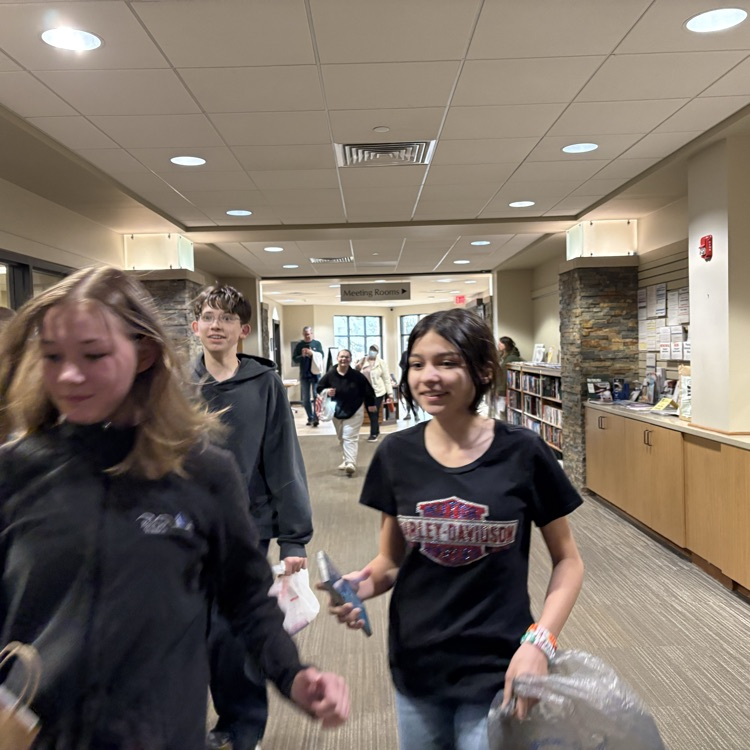 teens running down an empty library entrance