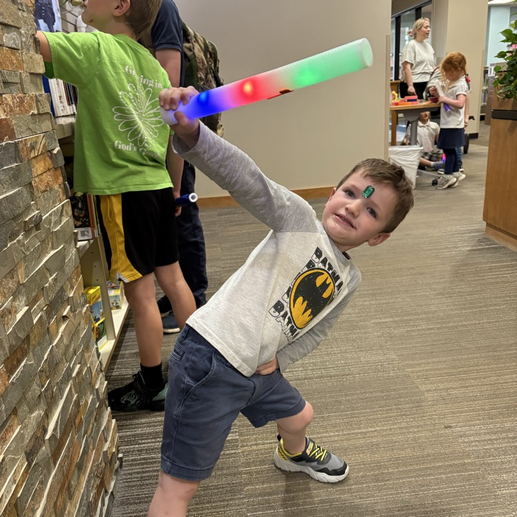 child wielding a lightsaber