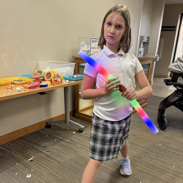 child wielding a lightsaber