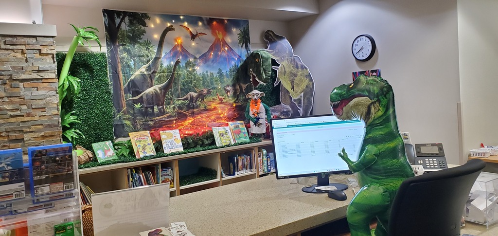 T-Rex Tea Time working at the desk