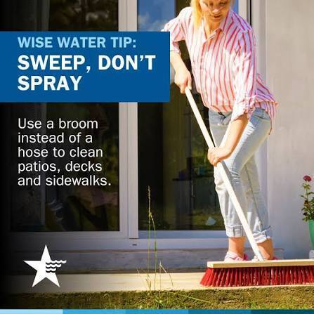 Sweep, don't spray text with a person pushing a broom