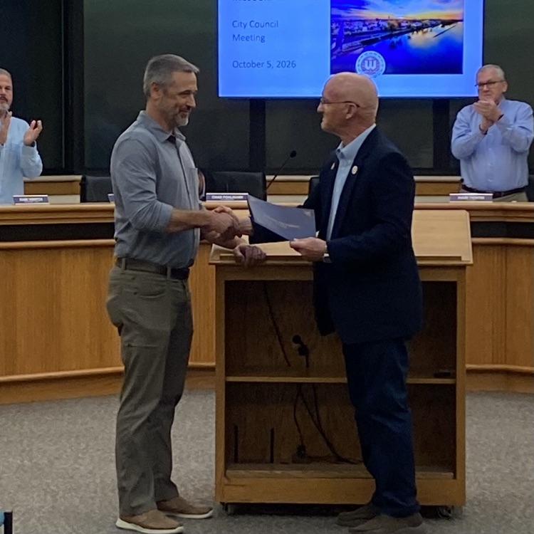 Mayor Hagedorn giving award to Clint Schneider