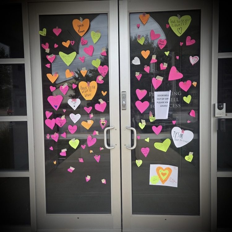HQ front doors decorated with paper hearts and messages