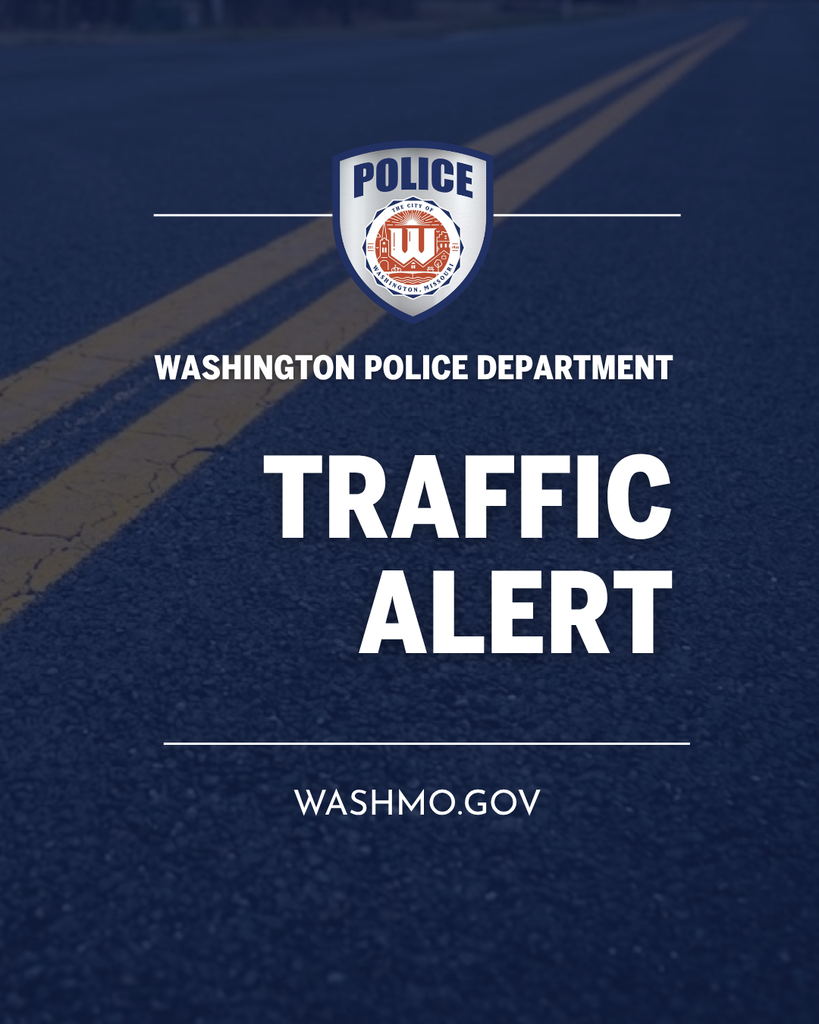 Pavement with double lines and text reading Washington Police Department TRAFFIC ALERT washmo.gov