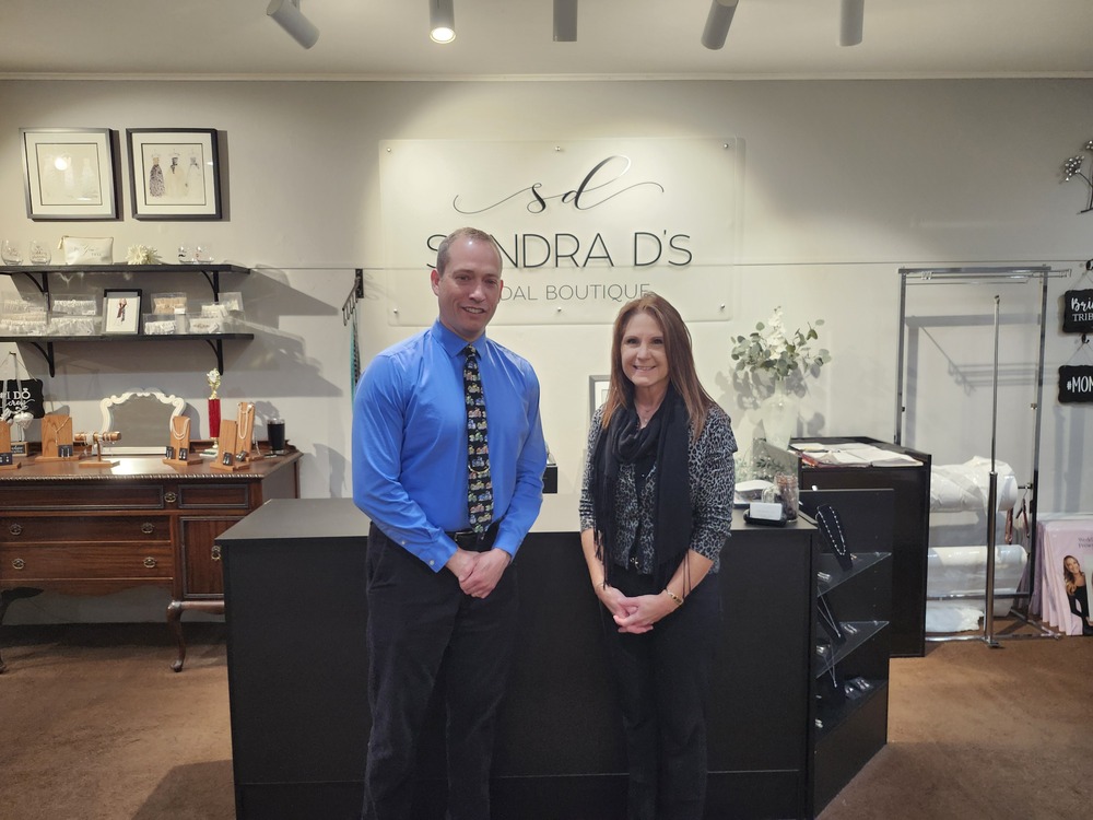 Mayor Stocks and Sandra, standing in front of the sales counter at Sandra D's Bridal boutique