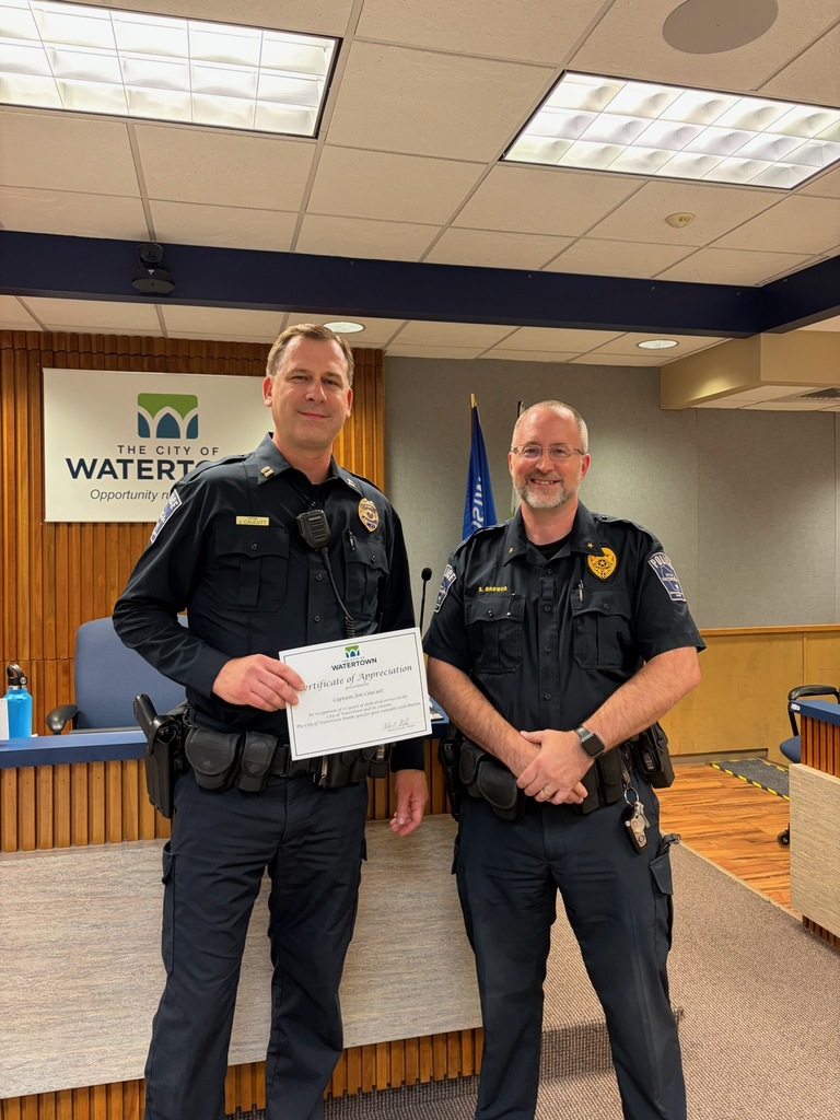Captain Caucutt celebrates 20 years of employment with the Watertown Police Dpartment with Chief Brower.