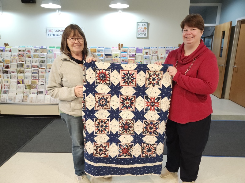 Quilt raffle winner Jody Weihert and staff member Megan Schwefel