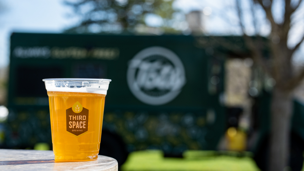 A cup of Third Space Brewing beer on a table.