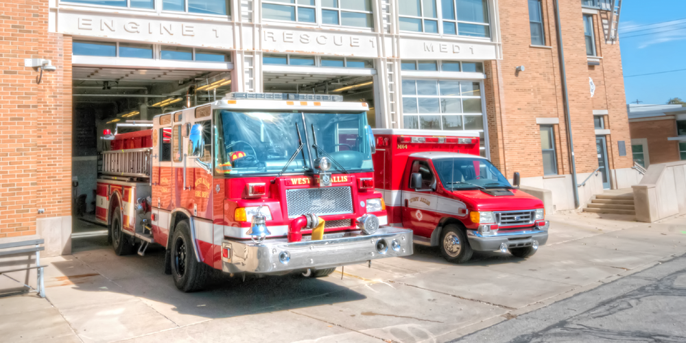 A fire truck and an ambulance parked at the fire house