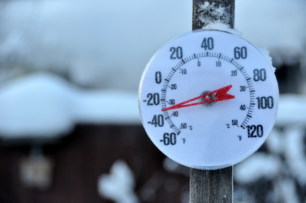 A photo of an outdoor thermometer on a pole showing a temp of -30F