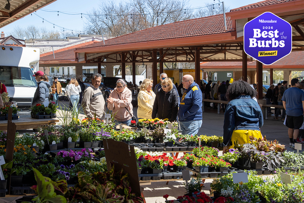Shoppers looking at flowers at the West Allis Farmers Market.